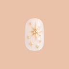 Confetti Sparkle - Press-On | Short | Round false nail with milky base and raised gold star accents for easy at-home mani