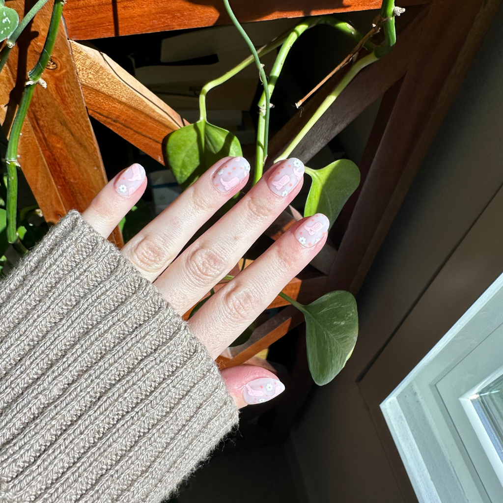Cowgirl Boot Boogie - Press-On | Extra Short | Round featuring pink floral print on short round press-on false nails on hand indoors