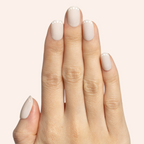 Dotted French | Short | Round - Tab Press-On showing short round neutral press-on nails with white dot French tip design on hand