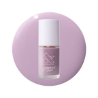 Bottle of Dreamy sheer milky pastel lavender quick dry gel polish on matching circular background for manicure use