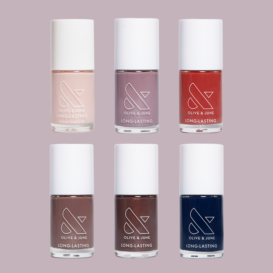 Six bottles of Olive and June Fall Long-Lasting Polish Set in muted and rich fall-inspired colors for manicures and pedicures
