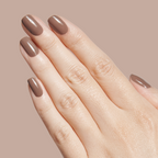 Hand with nails painted in Fawn - Gel, a glossy minky brown neutral gel polish against a matching beige background