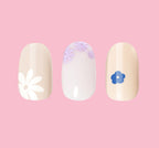 Floral Trio showing three beige and white press-on nails with delicate blue and purple floral designs for easy mani application