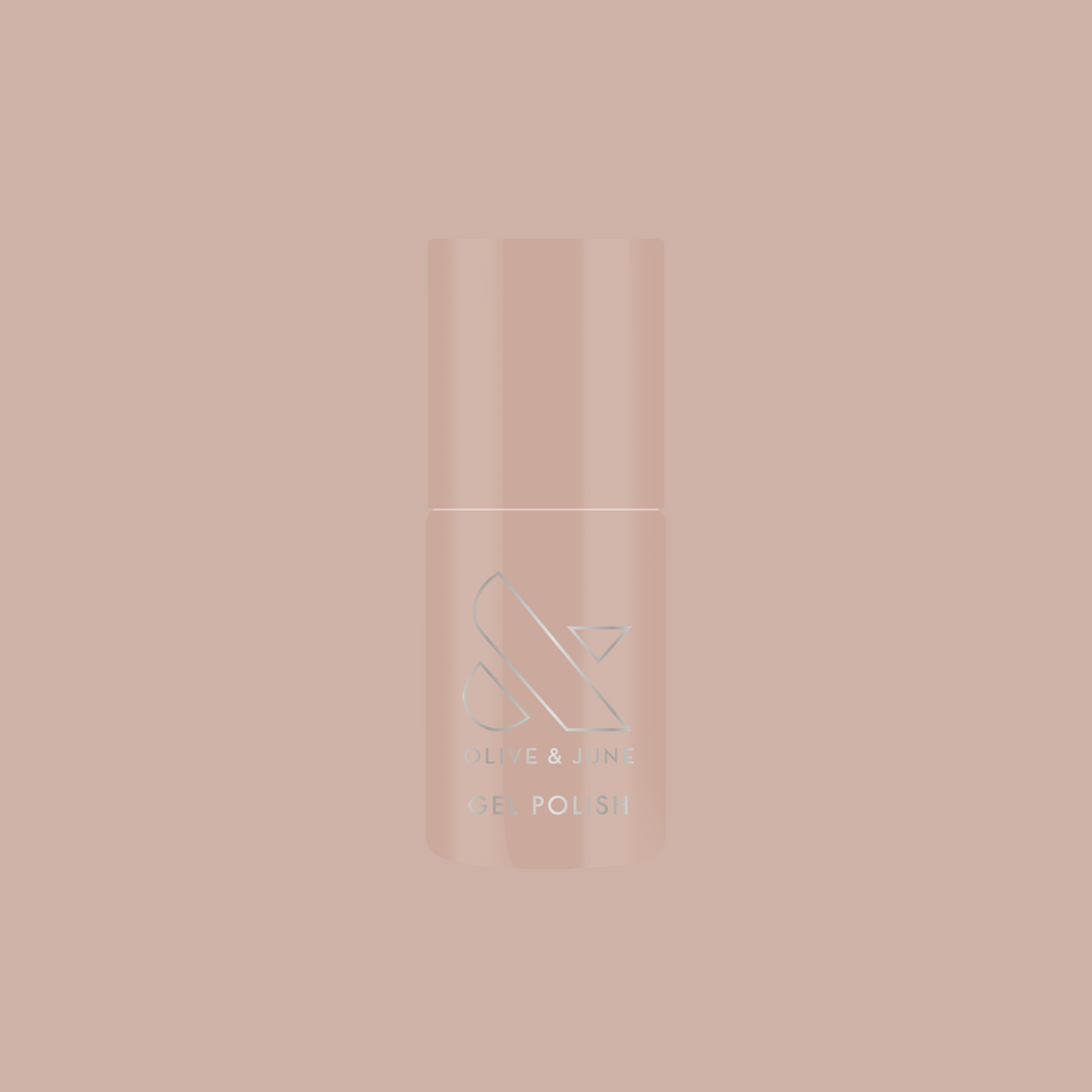Bottle of CDJ - Gel nail polish by Olive and June in creamy neutral shade on matching soft background