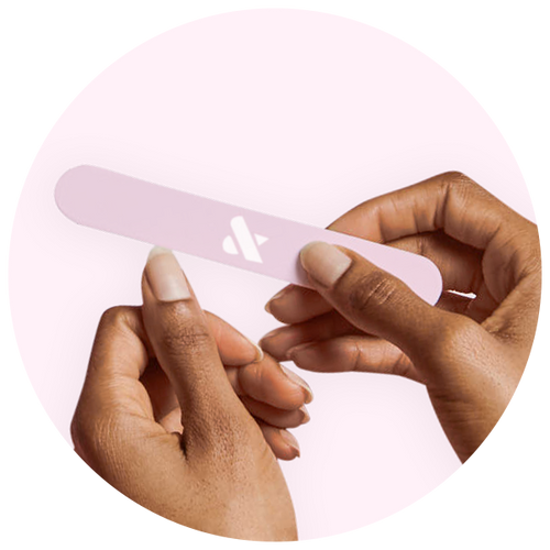Hands filing nails with a pink nail file as part of the Mani Prep Set for a smooth manicure base
