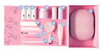 Open flat layout of a pink manicure kit with numbered gel polish, brush, file, and curing light components