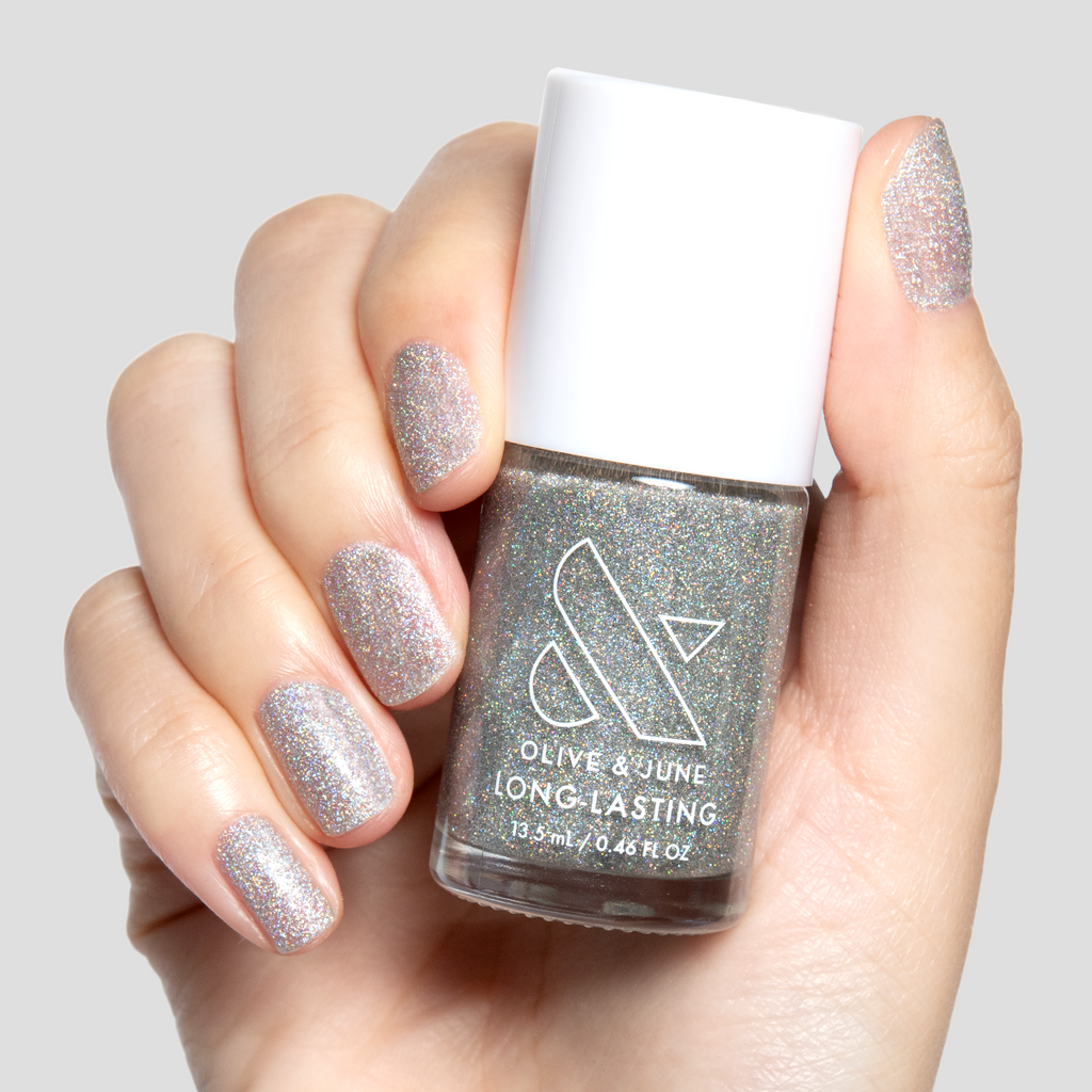 Glitter Department silver holographic polish on nails with a shimmering long-lasting mani by Olive and June