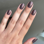 Hand with Goal Getter - Tab Press-On | Extra Short | Round nails in chocolatey neutral with golden shimmer for a polished mani