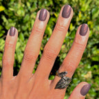 Hand with Goal Getter - Tab Press-On | Extra Short | Round nails in chocolatey neutral with golden brown shimmer outdoors