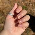The Golden Effect Top Coat giving natural nails a luminous golden hour glow for a radiant and long-lasting manicure. thumbnail