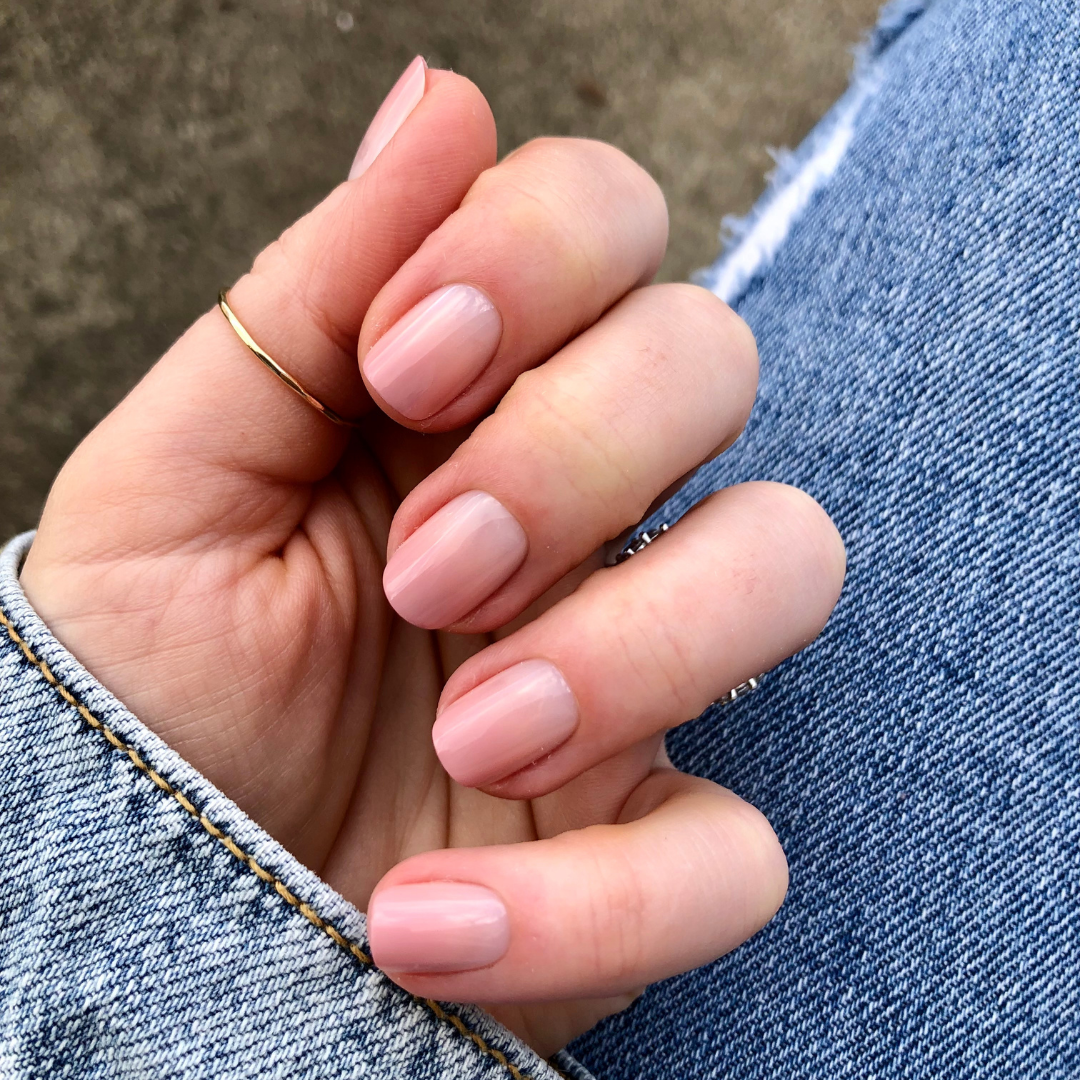 HZ Syrup Gradient - Press-On | Extra Short | Squoval showing hand with extra short squoval nails in rosey-beige gradient mani on denim background