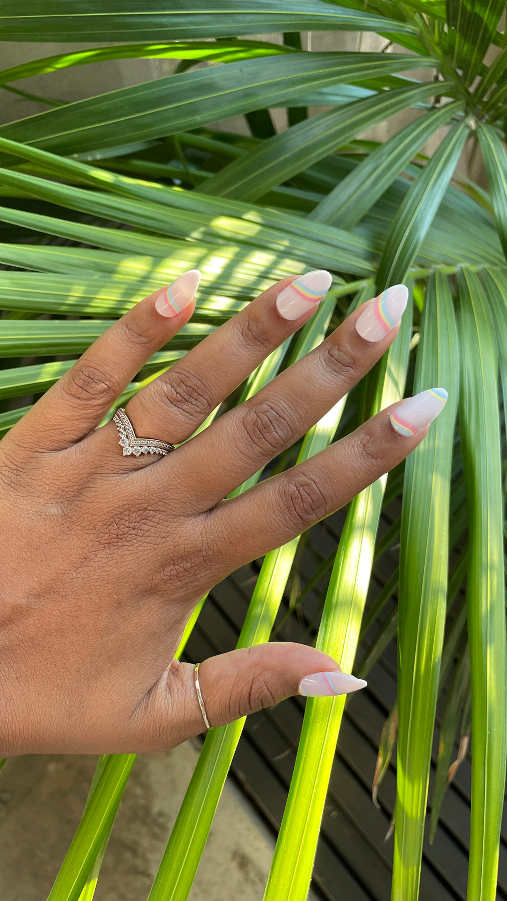 Rainbow Swirl - Press-On | Medium | Almond false nails with pastel rainbow lines on natural base for an easy at-home mani