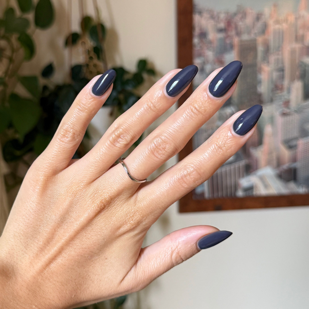Hand with almond shaped nails painted in glossy Inkling gel polish showing a smooth quick dry manicure indoors