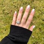 Chrome French - Press-On | Medium | Oval showing natural hand with medium oval press-on nails and classic thick white french tips outdoors