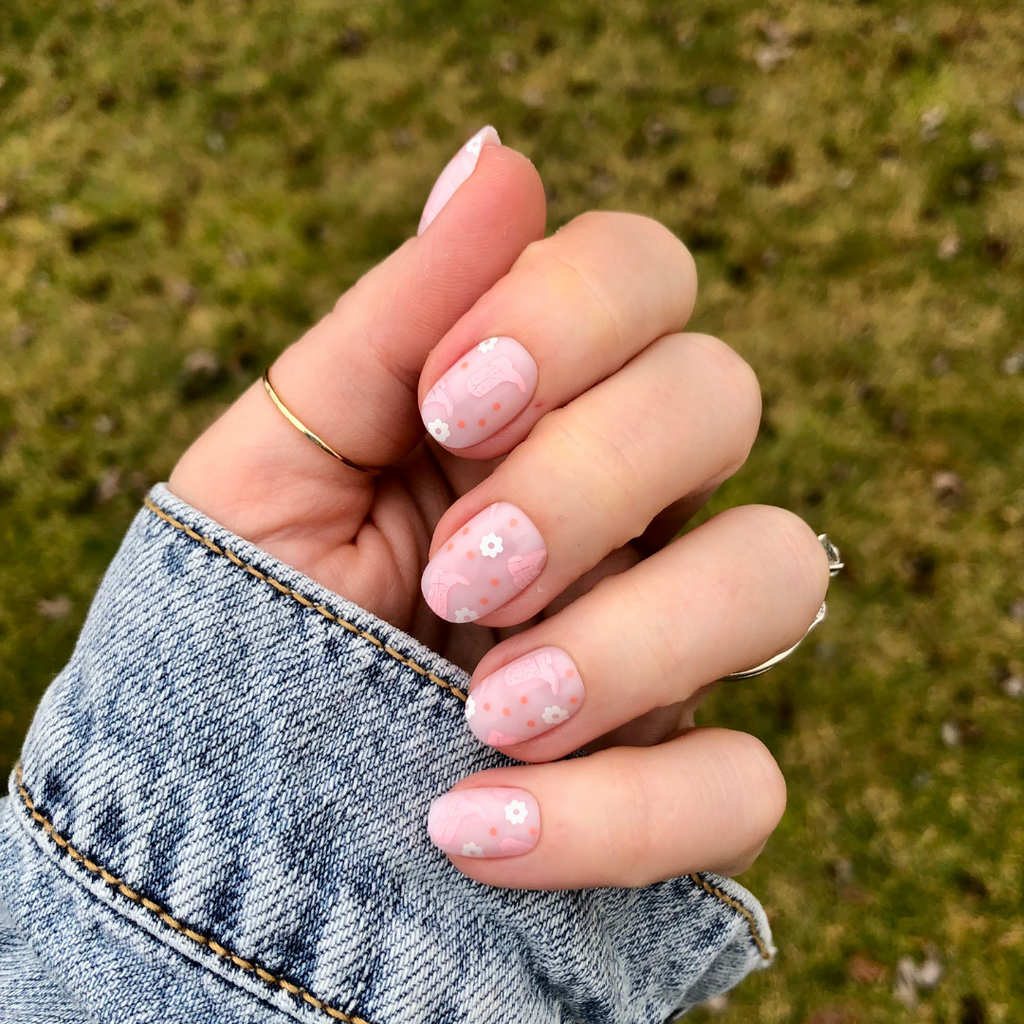 Cowgirl Boot Boogie - Press-On | Extra Short | Round showing pink floral and cowgirl boot designs on short false nails outdoors