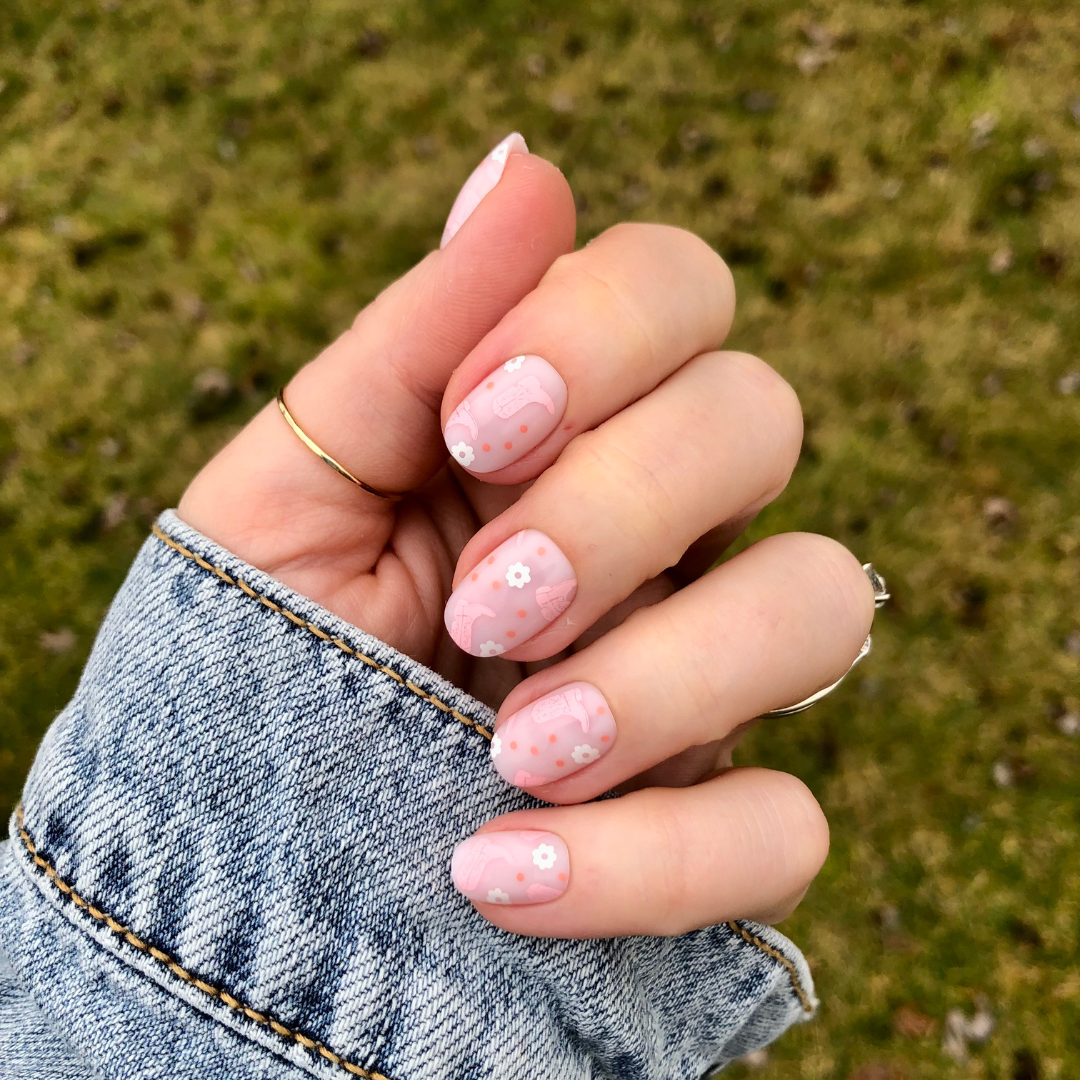 Cowgirl Boot Boogie - Press-On | Extra Short | Round showing pink floral and cowgirl boot designs on short false nails outdoors
