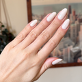 Hand showing almond-shaped nails in soft grey neutral with pink undertone manicure using LHG - Gel polish thumbnail