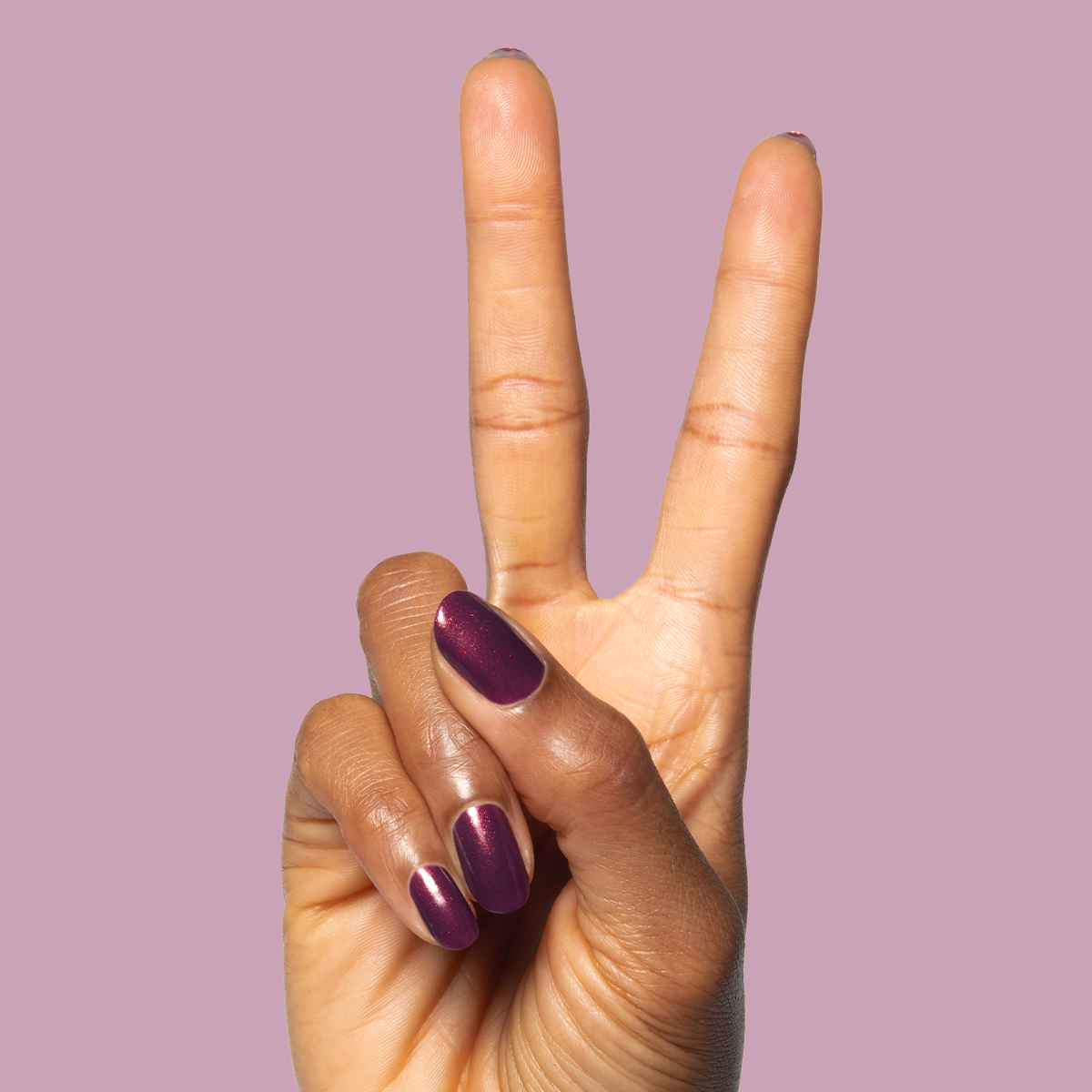On the Promenade shimmering mulberry purple gel polish on nails for a stylish and long-lasting at-home mani