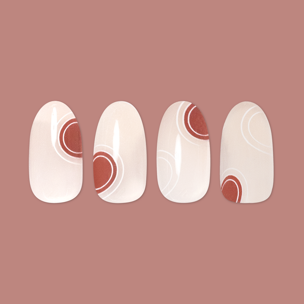Layered Circles - Press-On | Medium | Oval neutral press-on nails with burnt orange circles and white swirl accents manicure