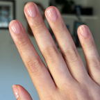 Lilac Luxe - Builder Gel on natural short nails with a translucent pinky purple gel polish manicure in soft indoor light