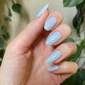 The Mermaid Effect Top Coat adding a subtle iridescent blue-green shimmer to pale blue gel polish for a fresh manicure thumbnail