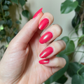 The Mermaid Effect Top Coat with iridescent pink shimmer and blue-green shift on vibrant red nails for a glossy mani thumbnail