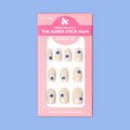 Mod Flowers | Short | Round - Tab Press-On nails in neutral polish with modern blue floral accents in pink packaging on blue background