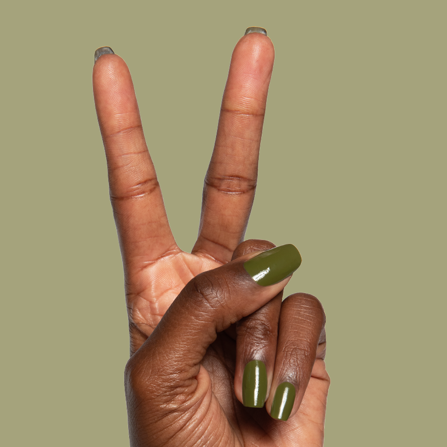Hand showing peace sign with glossy Mossy quick dry gel polish manicure on natural nails against plain background