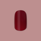 Mulberry | Extra Short | Squoval - Tab Press-On showing deep mulberry maroon glossy press-on nail on pink background