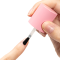 Nail Hardener being brushed on natural nail for strengthening and protection during at-home manicure care. thumbnail
