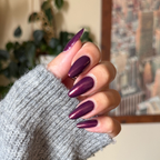 On the Promenade shimmering mulberry purple gel polish on almond-shaped nails for a chic at-home manicure look