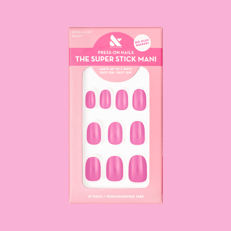 Peony | Extra Short | Round - Tab Press-On nails in bright pink with glossy finish arranged in packaging on pink background