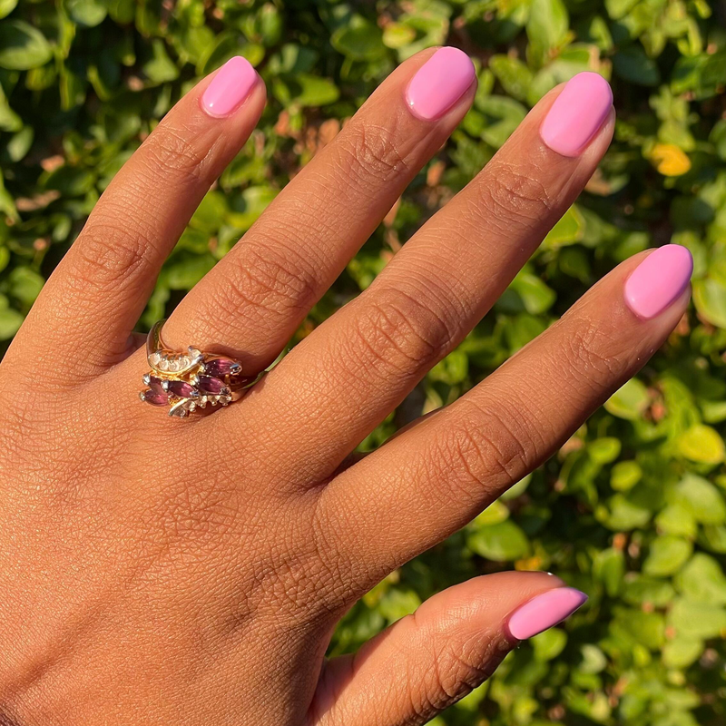Permanent Vacation - Gel bright pink gel polish on natural nails shown outdoors for a fresh manicure look