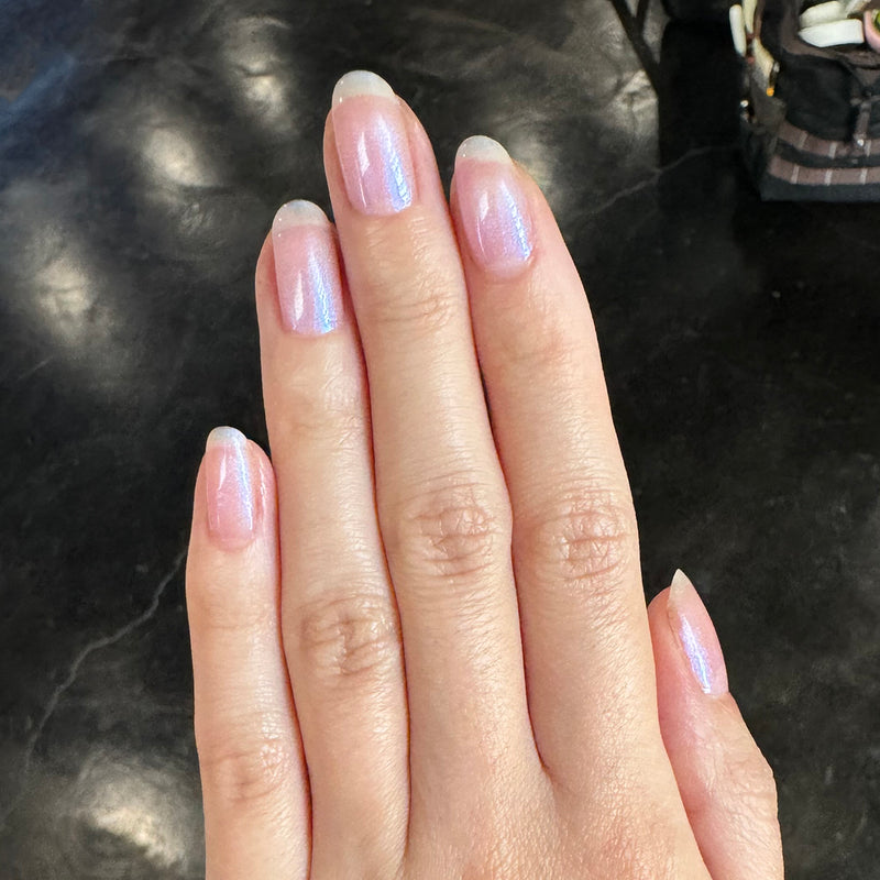 Bestsellers Gel Polish Set showing natural nails with soft pink iridescent gel polish for a subtle at home manicure
