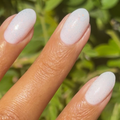 The Pixie Effect Top Coat adding a subtle iridescent shimmer over pastel polish for a delicate manicure look thumbnail
