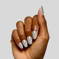 Hand showing nails coated in shimmering silver polish with magnetic effect from Magnetic Gel Polish Set manicure collection thumbnail
