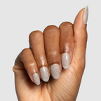 Glitter Department Gel on almond-shaped nails with holographic silver sparkle for a festive at-home manicure