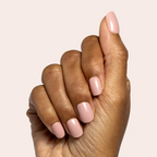 Poodle | Extra Short | Squoval - Tab Press-On nails in neutral beigey pink on hand with natural light background