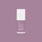 Bottle of Dreamy sheer milky pastel lavender quick dry gel polish by Olive and June on a matching lavender background