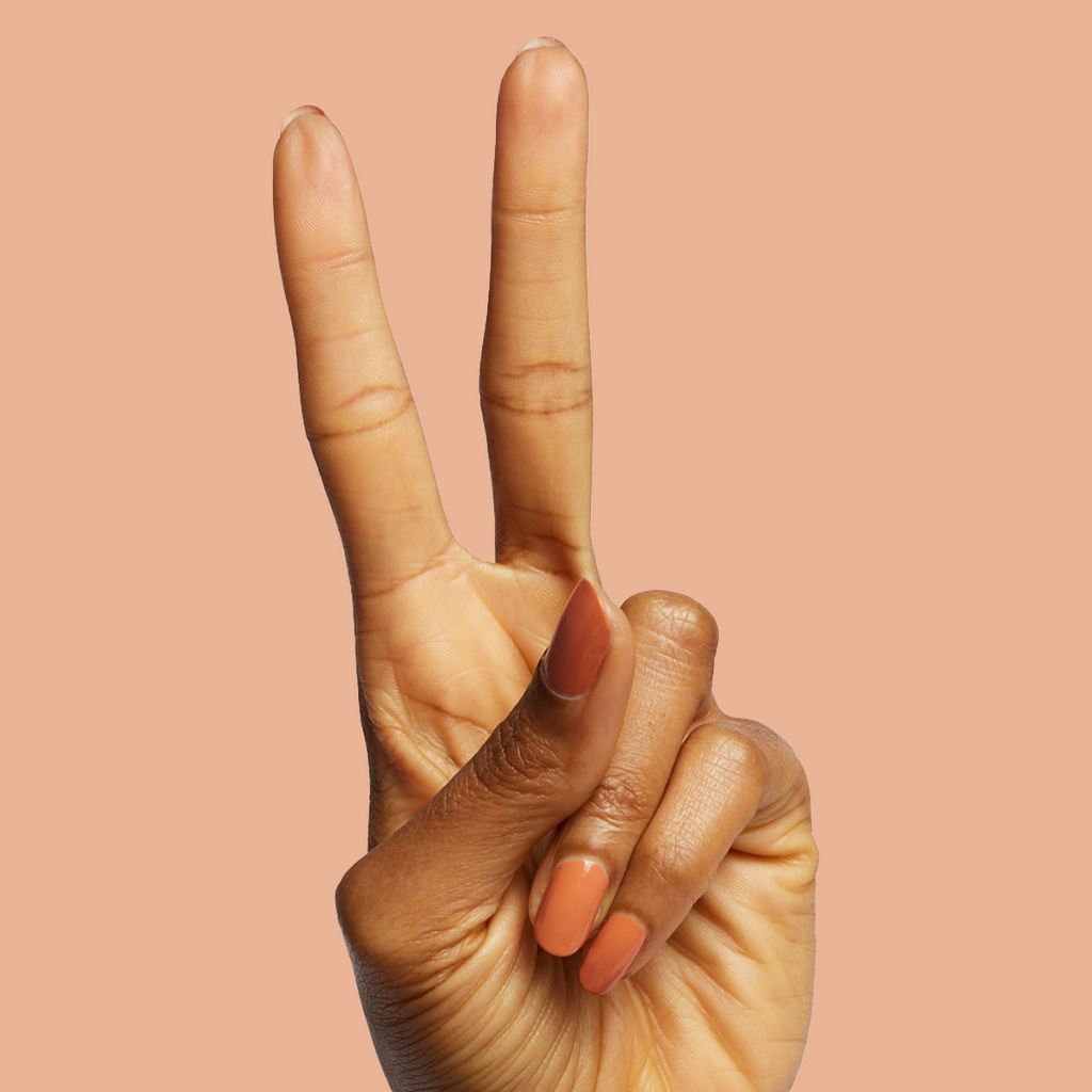 Hand showing peace sign with Canyon warm desert orange gel polish for easy at-home manicure and mani options