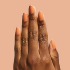 Hand with Canyon warm desert orange gel polish on nails for long-lasting at home manicure and mani options