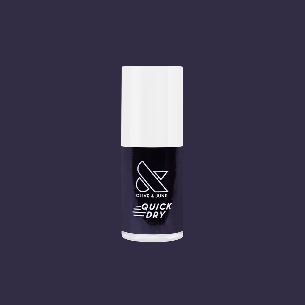 Olive and June Covet quick dry polish bottle in cool dark plum shade on solid deep purple background