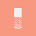 Peeptoe quick dry nail polish bottle in warm peach shade against matching smooth peach background