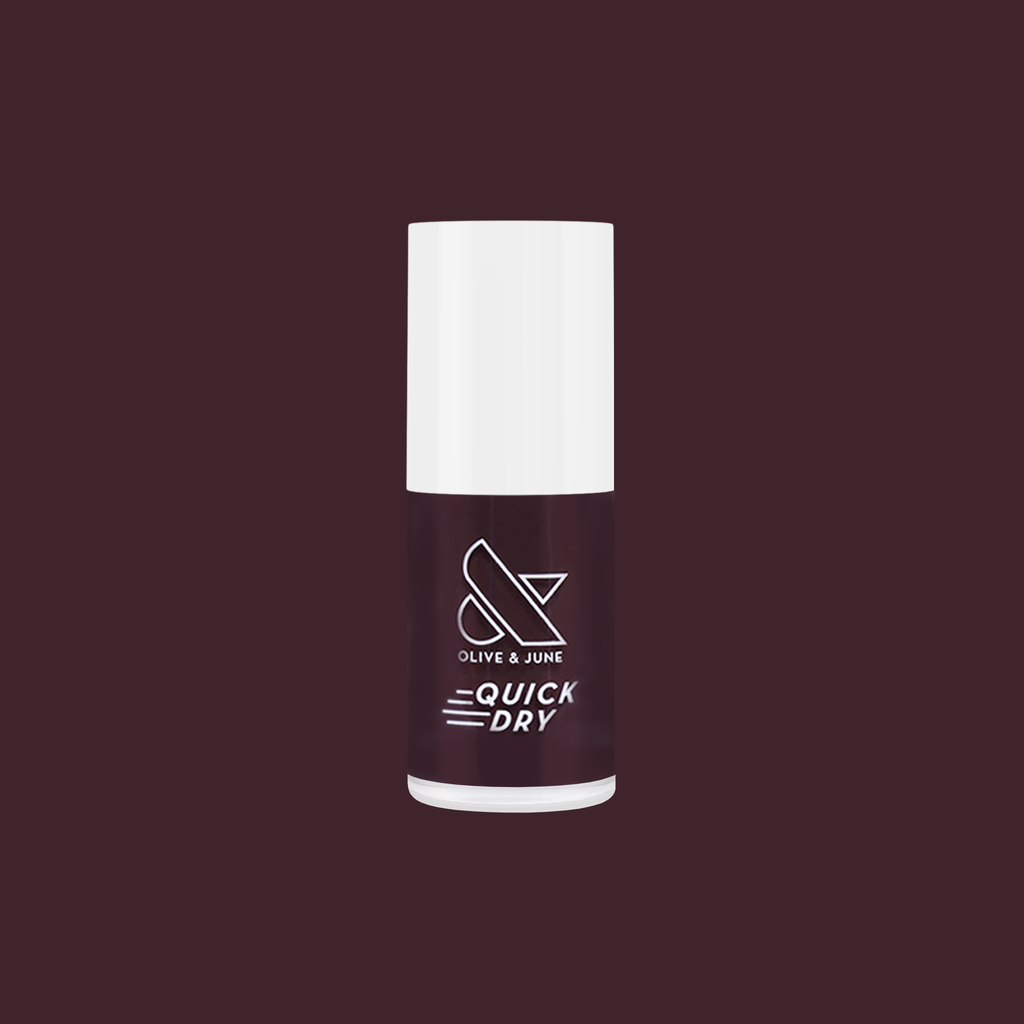 Spressotini quick dry gel polish bottle in dark coffee brown shade against deep plum background