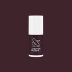 Spressotini quick dry gel polish bottle in dark coffee brown shade against deep plum background