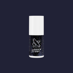 Olive and June Stargaze quick dry polish bottle in inky black with sparkling rainbow glitter on dark blue background
