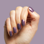 Hand with Twilight gel polish showing a glossy, iridescent violet manicure on light skin tone against a purple background