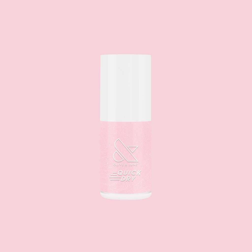 Crown shimmery pink quick dry gel polish bottle on pink background for at home mani and pedi use