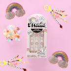 Rainbow Connection - Pressies | Extra Short Short | Round showing pastel pink press on nails with rainbow accents in packaging on pink background
