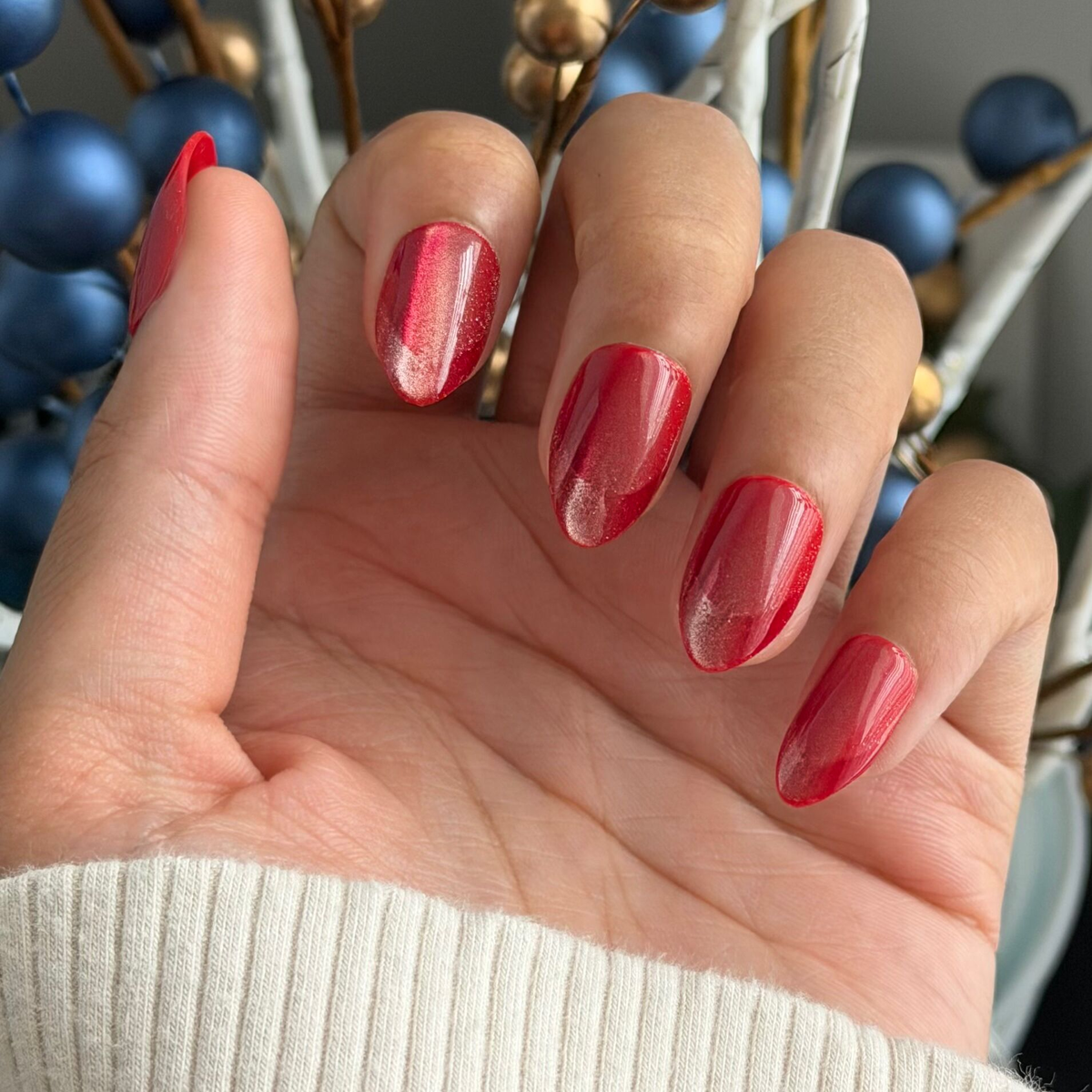 Close-up of hand wearing Red Illusion Velvet French - Press On | Medium | Almond nails with cherry red velvet and subtle french tip effect